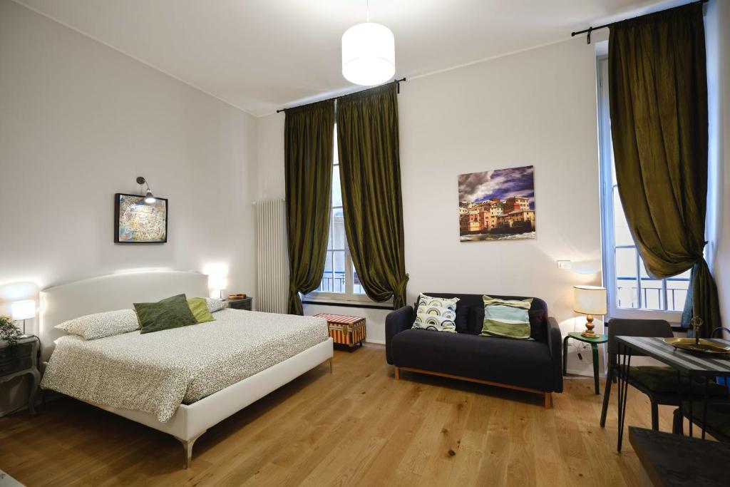 a bedroom with a bed and a chair in it at Rolli House in Genova