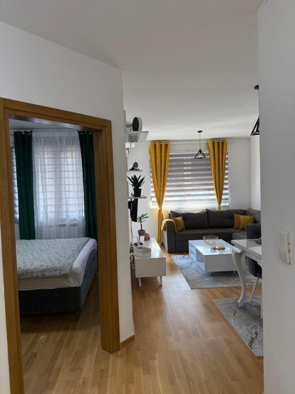 a living room with a bed and a couch at Nur Bulevar in Sarajevo
