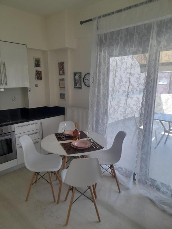 a kitchen with a table and chairs and a window at Anesis Premium Living in Ioannina