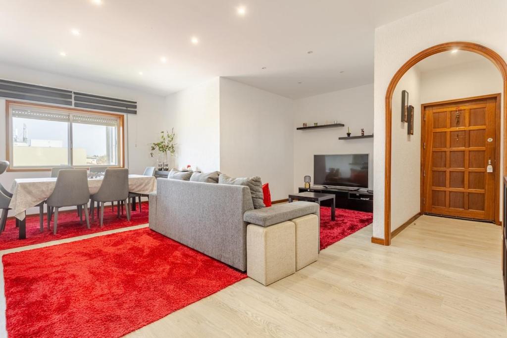 sala de estar con mesa y alfombra roja en LEÇA'S BEACH FLAT**AMAZING VIEWS**PORTO, en Leça da Palmeira