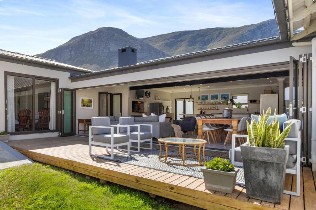 Un patio con una mesa y sillas en una terraza. en 8 on Nivenia by Host Agents, en Bettyʼs Bay