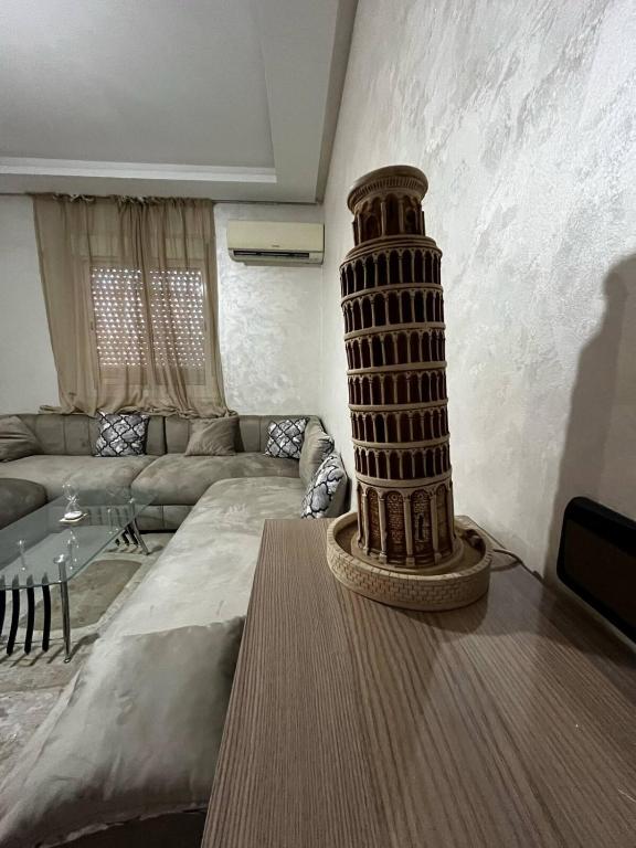a living room with a table with a tower on it at appartement Marrakech in Oulad Akkou