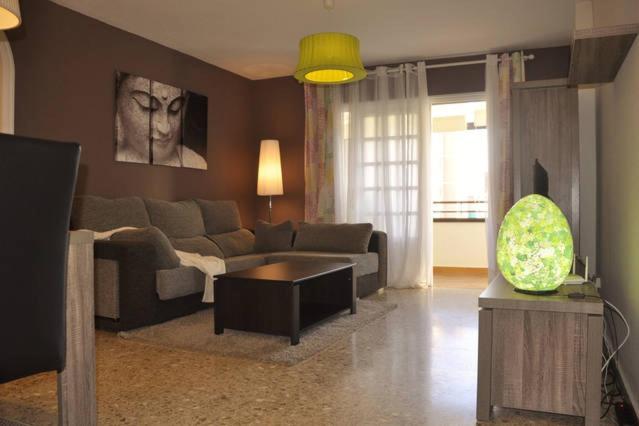 a living room with a couch and a table at Apartamento Puerto in Santa Cruz de Tenerife