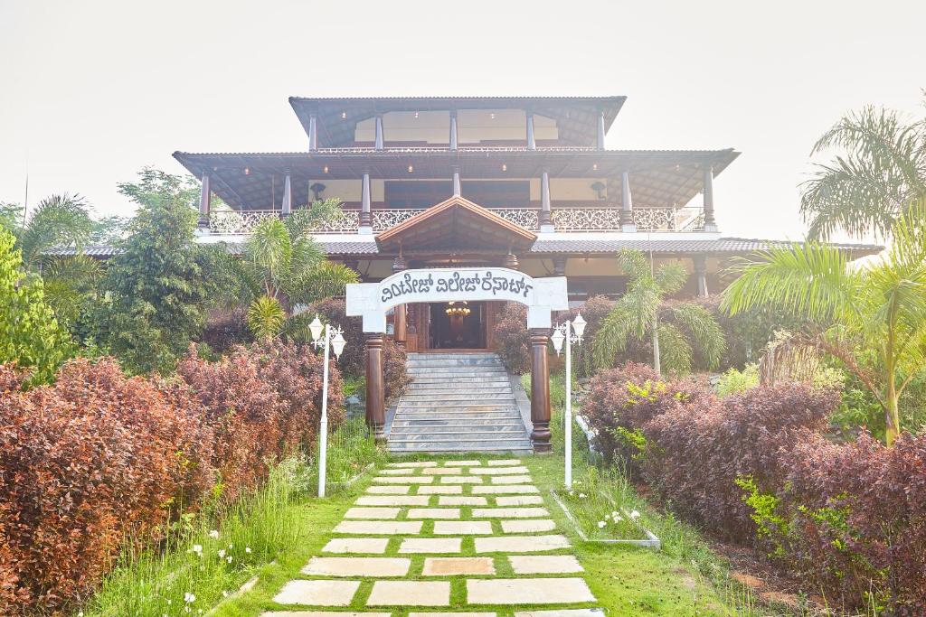 a building with a staircase leading up to a house at Vintage Trails By Ilara in Alūr