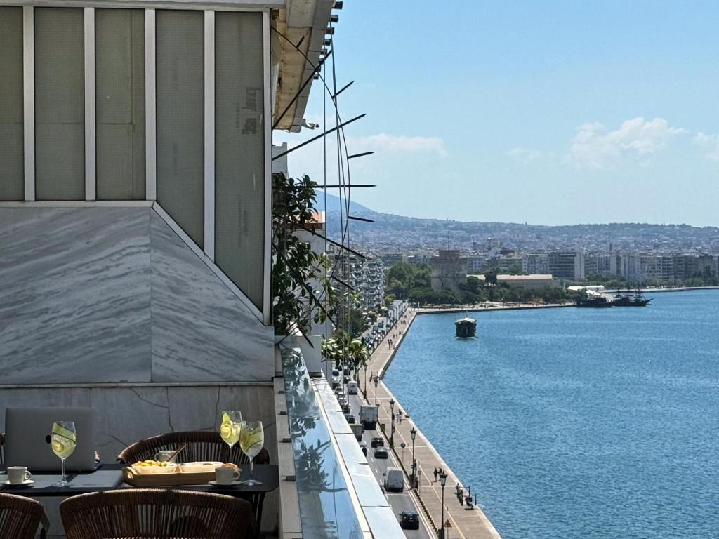 a view of the water from the balcony of a building at Zeusbnb Penthouse Sea View in Thessaloniki