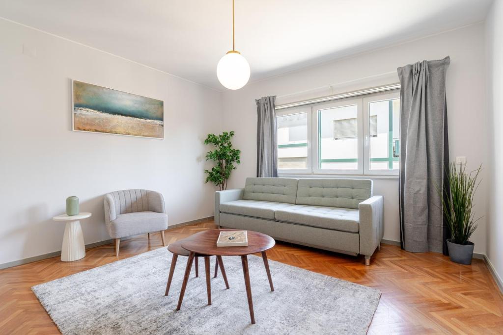 a living room with a couch and a table at HostWise - Bright & Spacious Flat w/ Garage in Porto