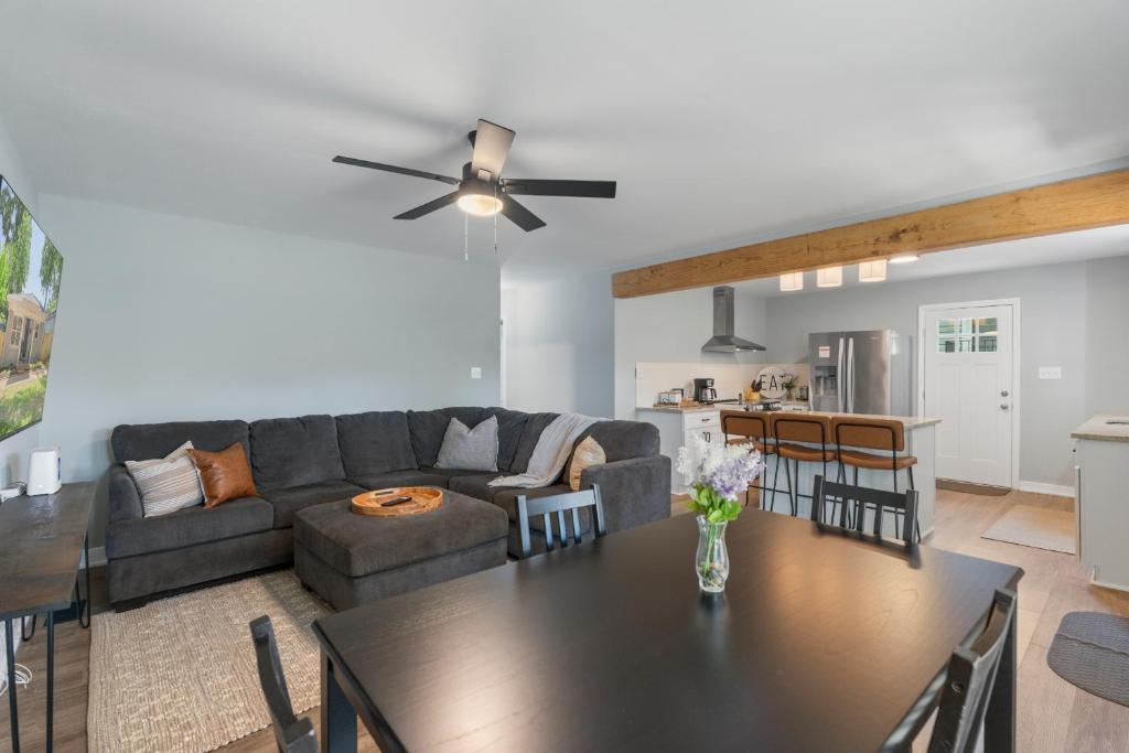 a living room with a couch and a table at Comfortable 4 Bedroom House Minutes from Uptown Charlotte in Charlotte