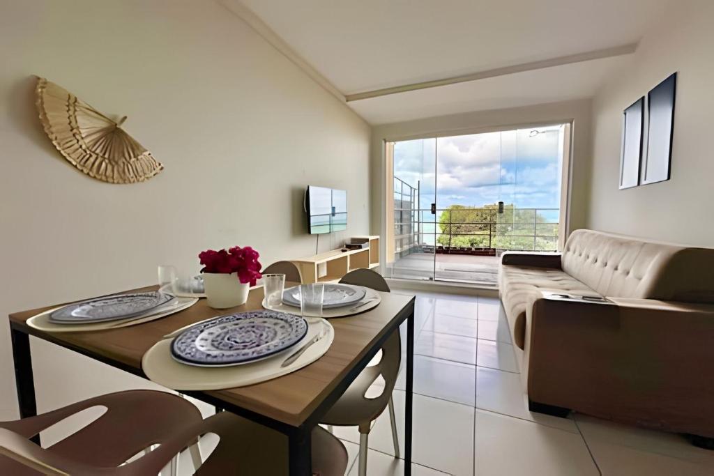 a living room with a table and a couch at Careca’s Beach Flat 302 in Natal