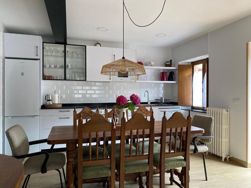 a kitchen with a wooden table and a dining room at Las nietas de Paco in Yermo