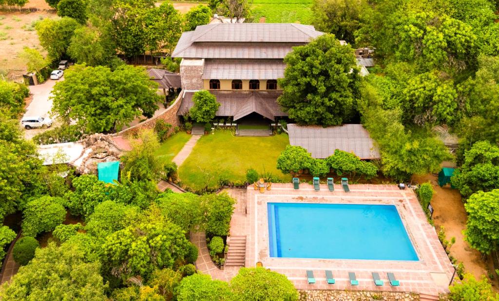 an aerial view of a house with a swimming pool at The Pugmark, A Wildlife Resort in Sawāi Mādhopur