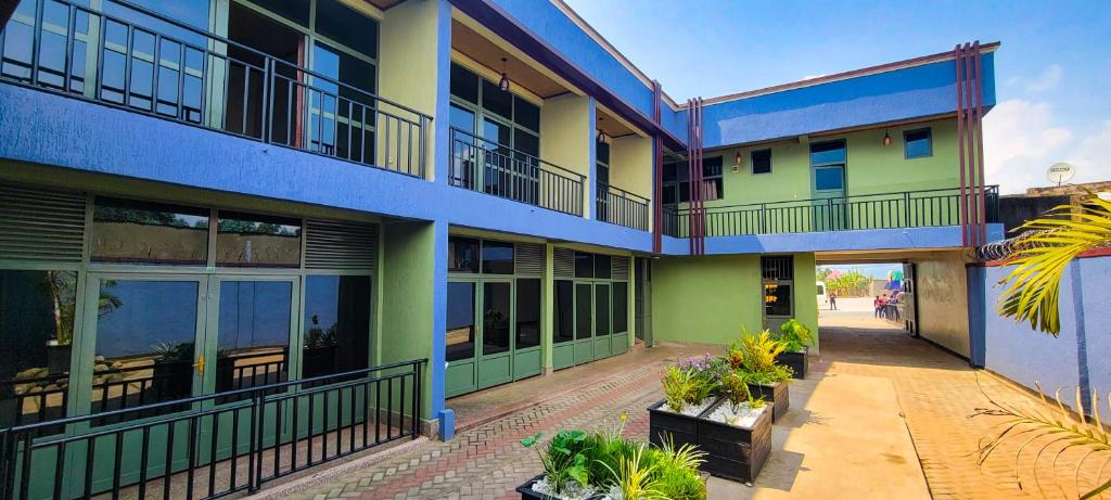 an apartment building with blue and green at Pacific Land Guesthouse in Burega