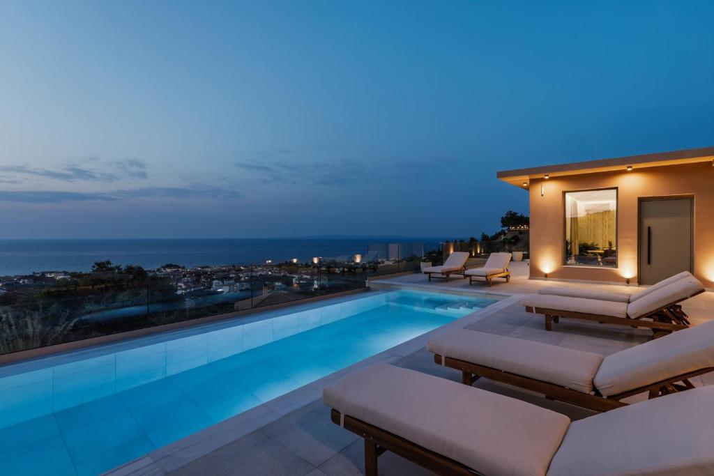 a pool on the roof of a house at Melody Blue Villa in Argassi