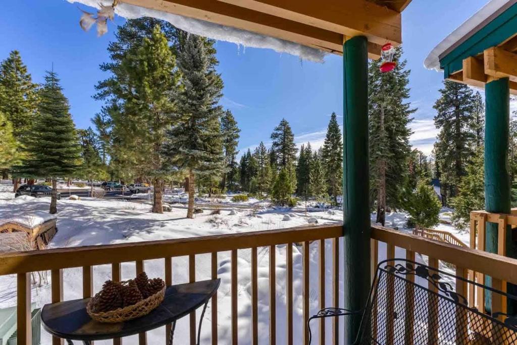 a winter view from the porch of a cabin with snow at TahoeCozy with Pool Hot Tub and Near Northstar in Tahoe Vista