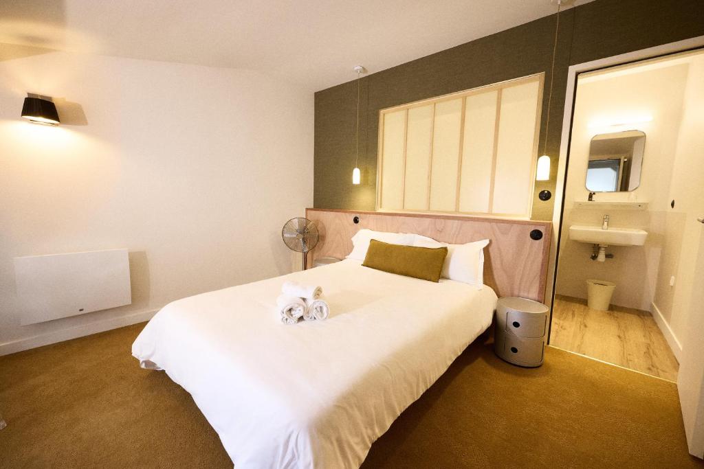 - une chambre avec un lit avec deux chiens assis dans l'établissement Hôtel Henri IV, à La Rochelle