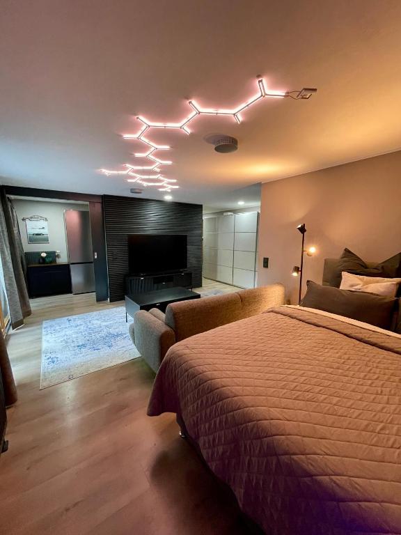 a bedroom with a bed and a couch and a fireplace at Luxus Apartment Hannover in Hannover