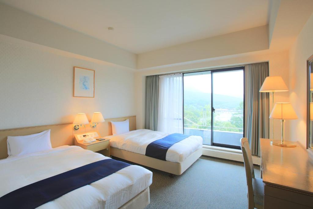 Postel nebo postele na pokoji v ubytování Izumigo AMBIENT Tateshina Hotel