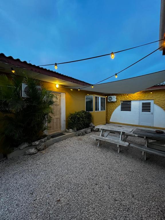 a picnic table in front of a building at Casa Caia - simple rooms and studios at studenthouse in Willemstad