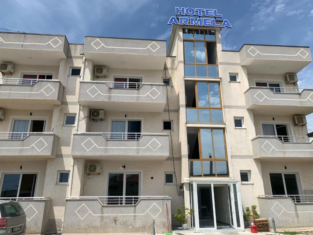 a building with balconies on the side of it at Hotel Armela in Velipojë