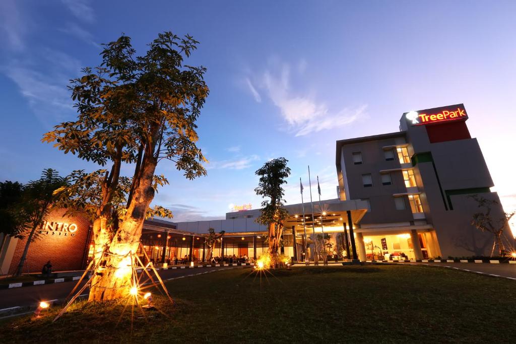 a hotel with a tree in front of a building at TreePark Banjarmasin in Banjarmasin