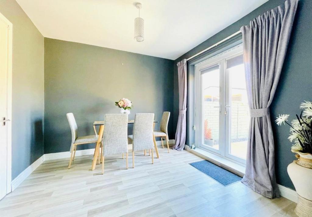 a dining room with a table and chairs and a window at Lovely accommodation closer to the beach in Hartlepool