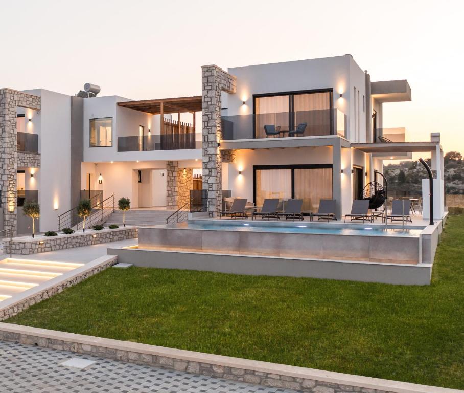 a modern house with a lawn in front of it at Blue Sunrise Villa 2 in Afantou