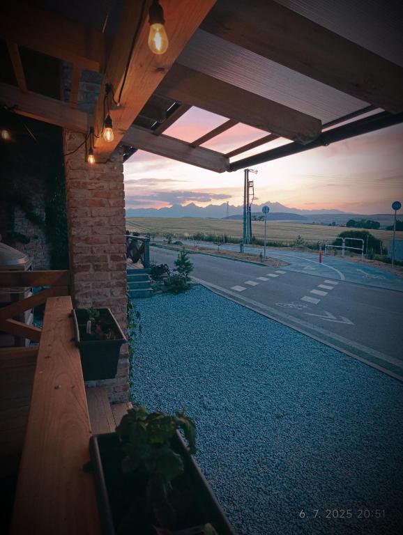 a patio with a view of a road and a building at Apartmán Stela in Spišské Tomášovce