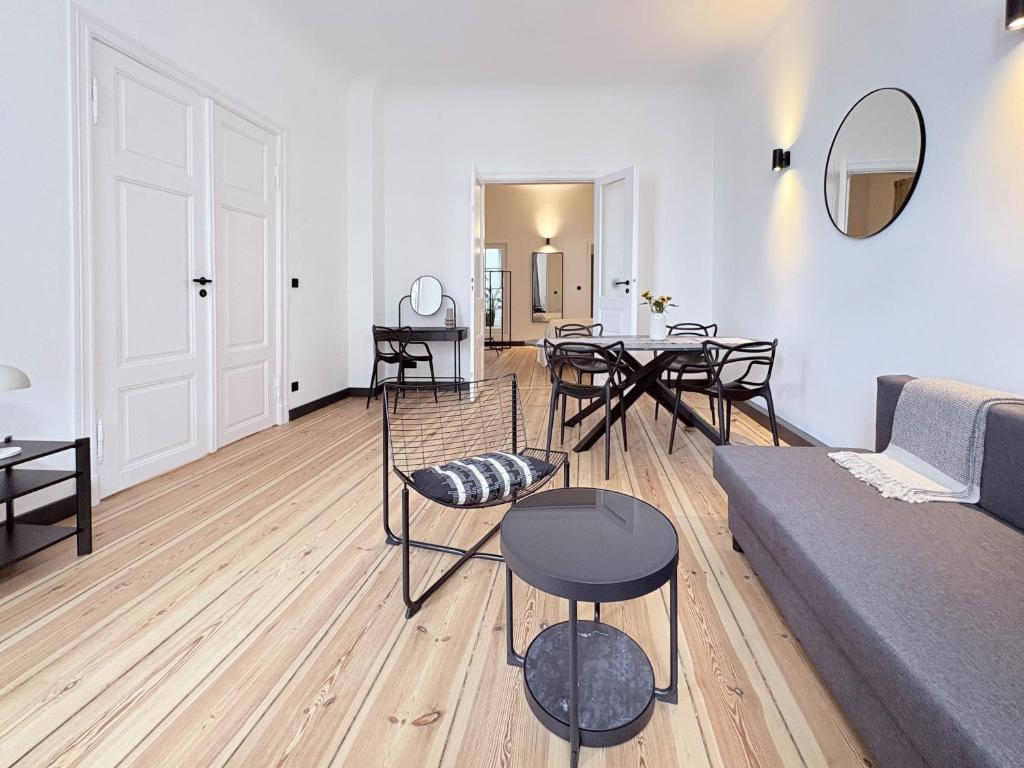 a living room with a couch and a table and chairs at Studios am Kniepertor Altstadt Stralsund in Stralsund