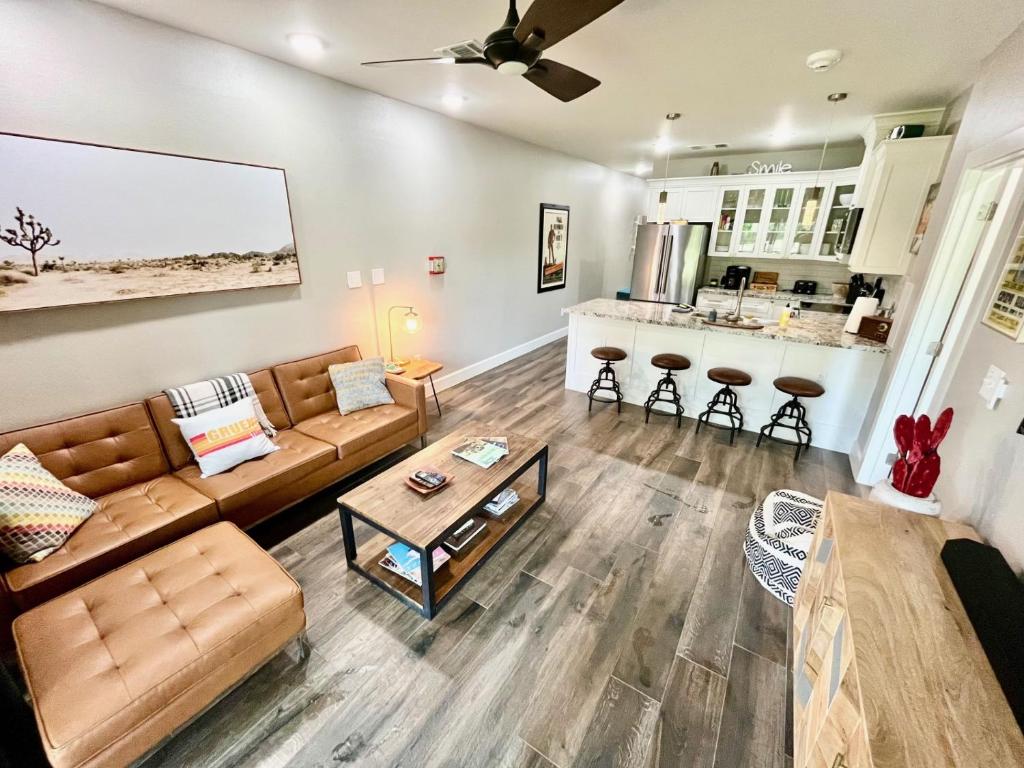a living room with a couch and a table at Hip Gruene Condo, Walk to Gruene Hall, On River! in New Braunfels