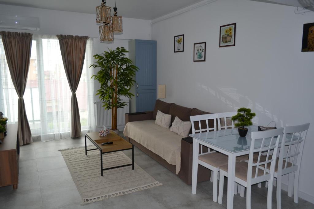 a living room with a couch and a table at Apartament POK in Constanţa