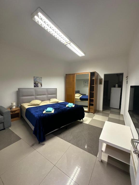 a bedroom with a bed with a blue comforter at Dubrovnik Inn in Dubrovnik