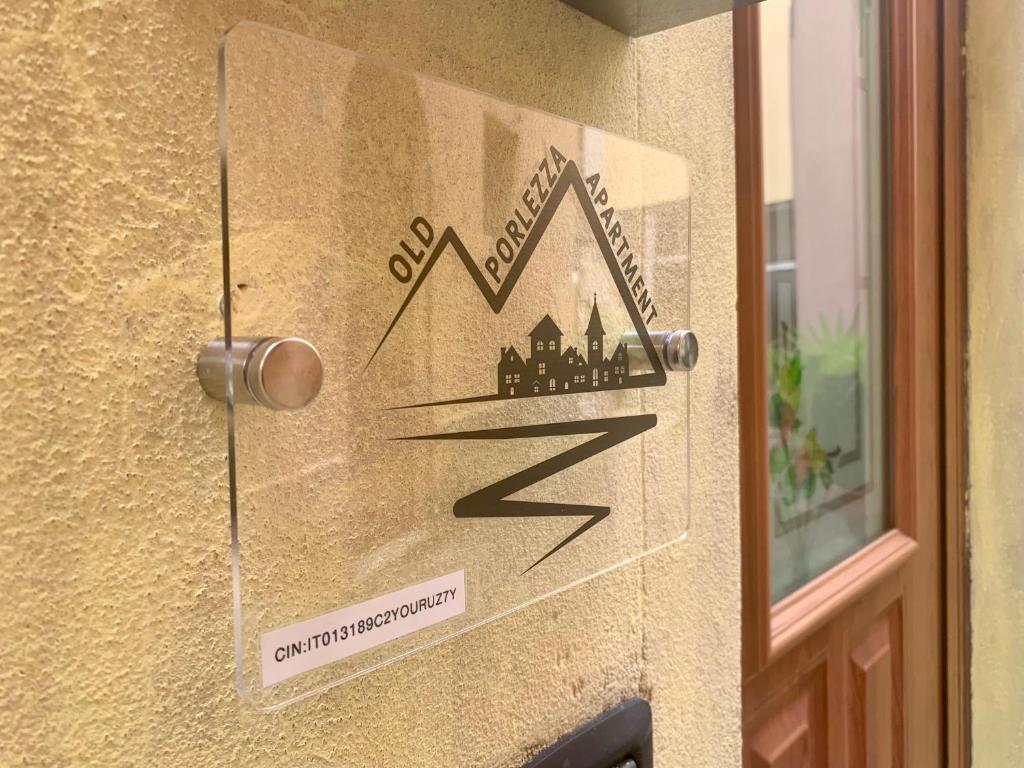a sign on the door of a building at Old Porlezza Apartment in Porlezza