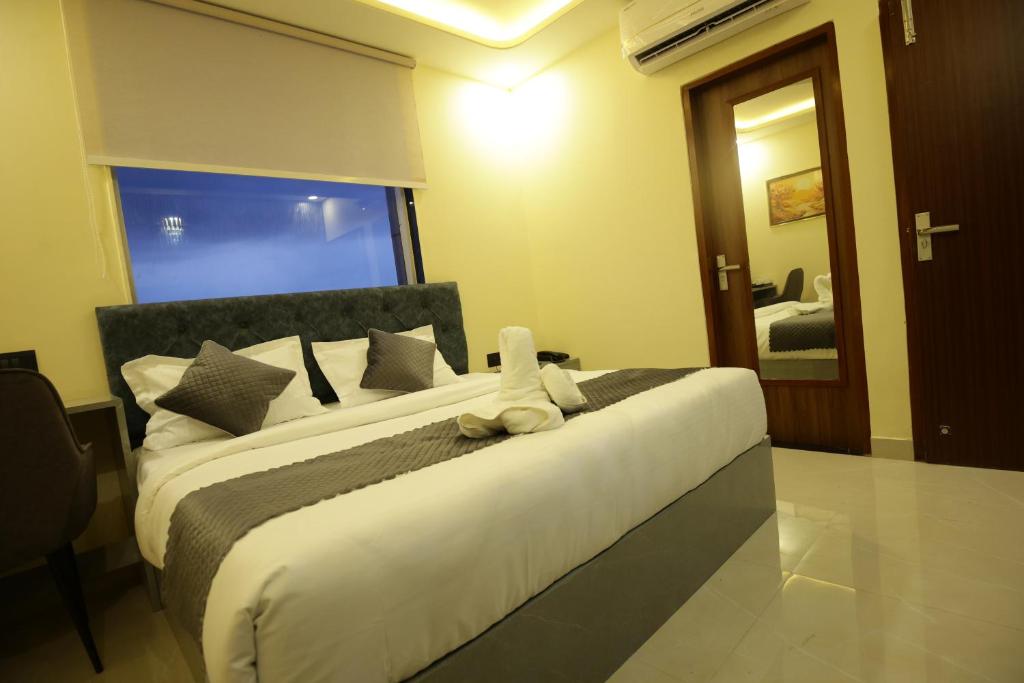 a bedroom with a bed with a stuffed animal on it at Hotel Neo in Jaipur