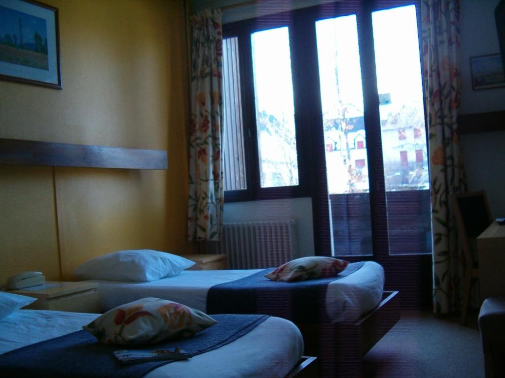 Postel nebo postele na pokoji v ubytování Le Grand Hôtel de Besse