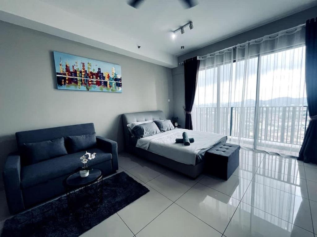 a bedroom with a bed and a couch at Aurora Homes at i-City - WiFi TV Box and 1 Carpark in Shah Alam