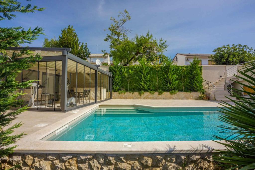 a swimming pool in the backyard of a house at Apartment in Crikvenica 41679 in Crikvenica