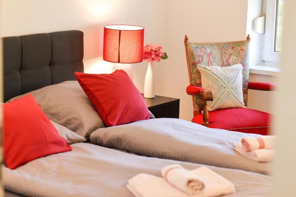 a bedroom with two beds and a lamp and a chair at Apartment Passau D, Zentral, Cozy, Parking Place in Passau