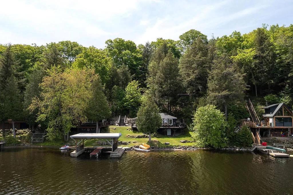 a view of a lake with boats in the water at Muskoka Cabana - Sandy beach cottage in Muskoka in Windermere