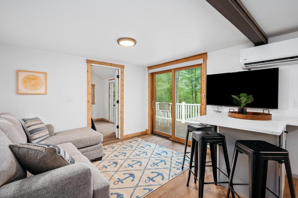 a living room with a couch and a table at Backwoods Cottage on Arbutus Lake in Traverse City