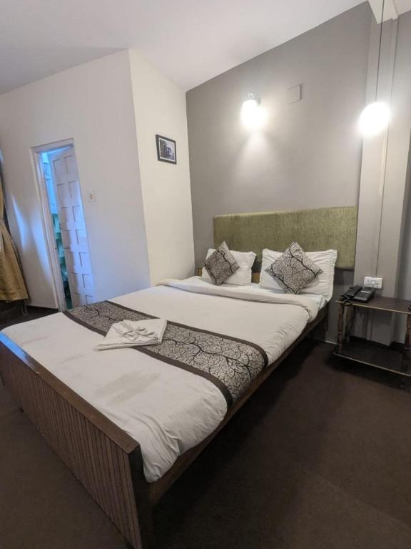 a bedroom with two beds in a room at Hotel Sakura Mountain view Near Darjeeling Toy Train Station in Darjeeling