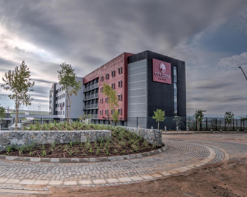 a building with a sign on the side of it at City Lodge Hotel Waterfall City in Midrand