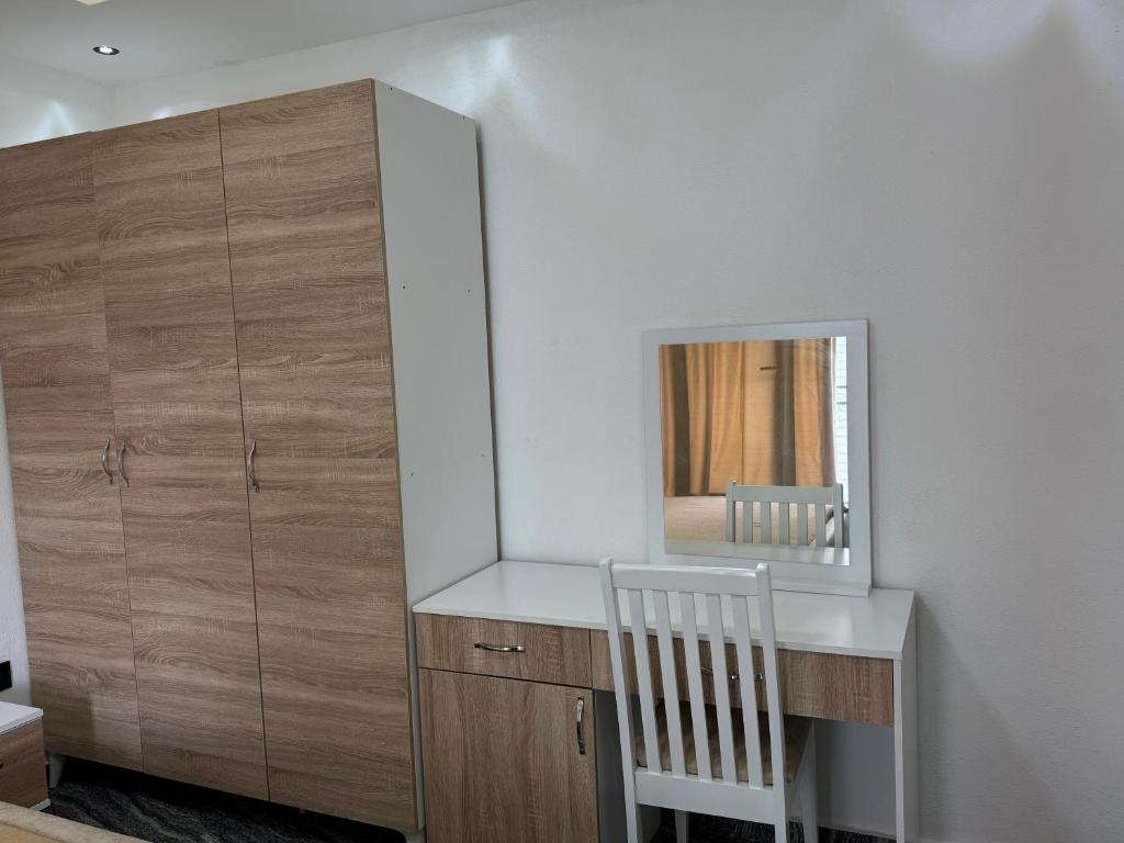 a white desk with a mirror and a chair at Aberdeen Richview Luxury Apartments- Entire One Bedroom Apartment D201 in Freetown