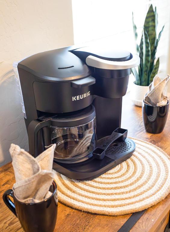 a coffee maker sitting on a wooden table at Karsten Maricopa in Maricopa