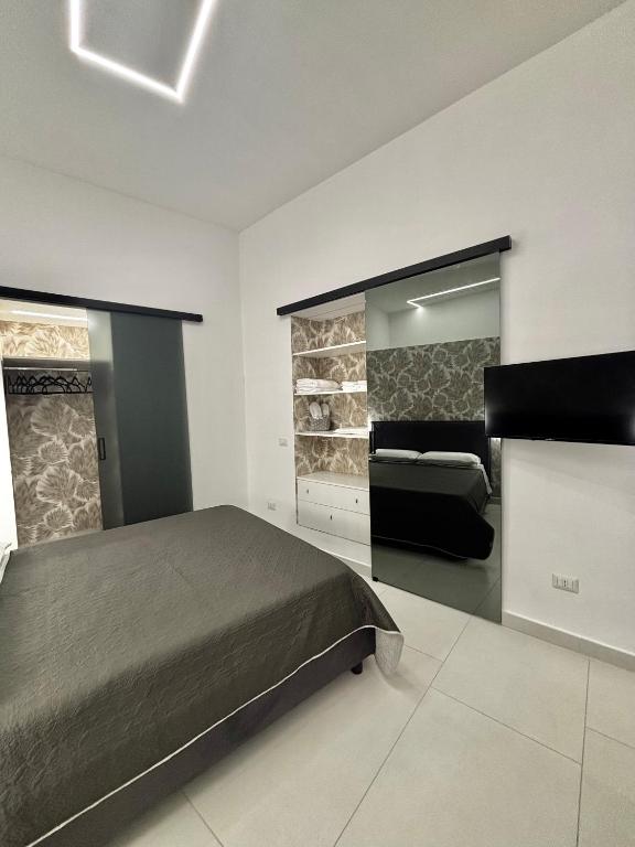 a bedroom with a bed and a mirror at Lindas Room in Pozzuoli