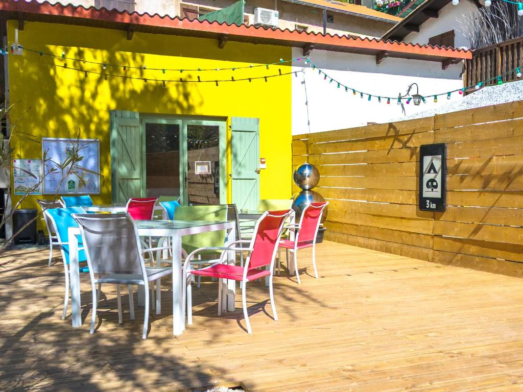 a patio with a table and chairs in front of a building at Camping 3* Les Templiers in Roquebillière