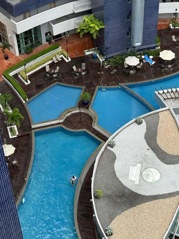 an overhead view of two pools in a hotel at 1605 dos quartos Beach Class Vista Mar in Fortaleza