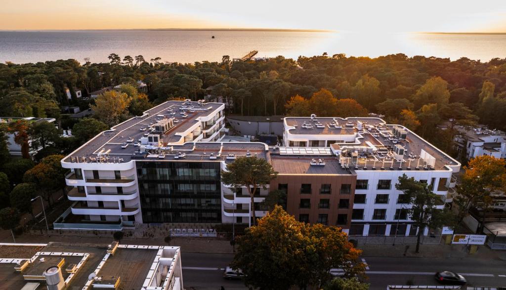 an aerial view of a building with the ocean in the background at LIDO by BlueApart in Jurata