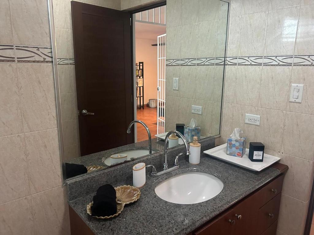 a bathroom with a sink and a mirror at The Yellow House: Fully Equipped, Spectacular Beach View in Manati