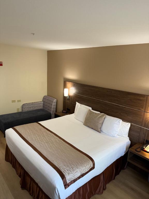 Postel nebo postele na pokoji v ubytování Evergreen Inn & Suites