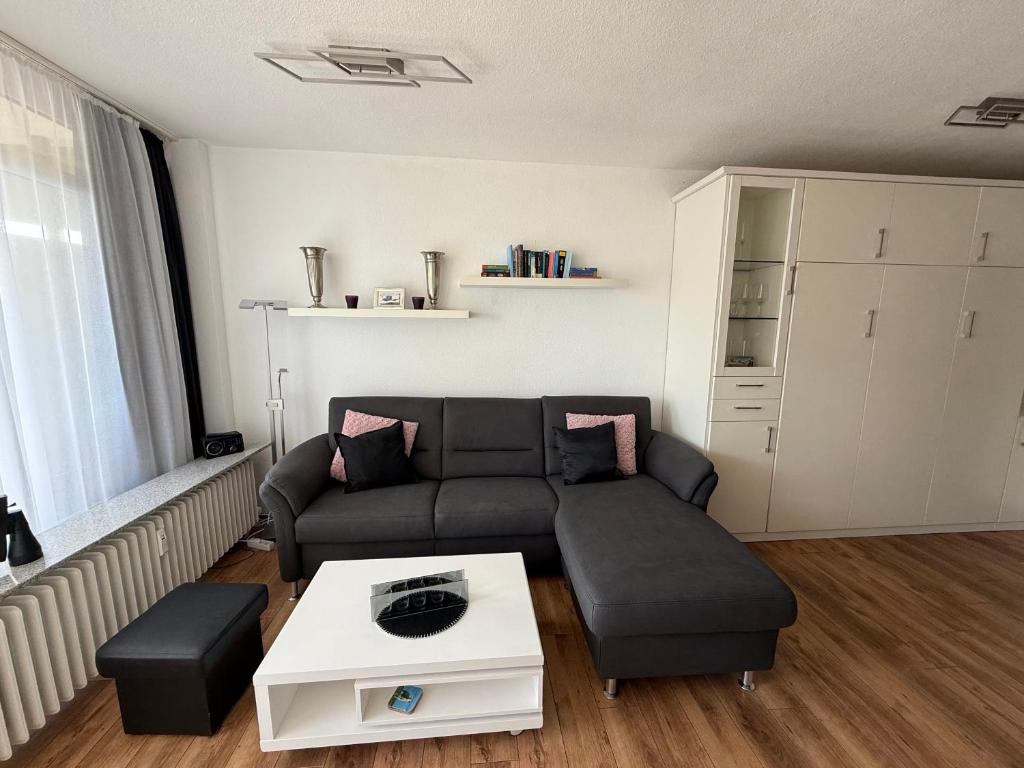 a living room with a couch and a coffee table at Panorama Whg 42, 2 OG in Cuxhaven