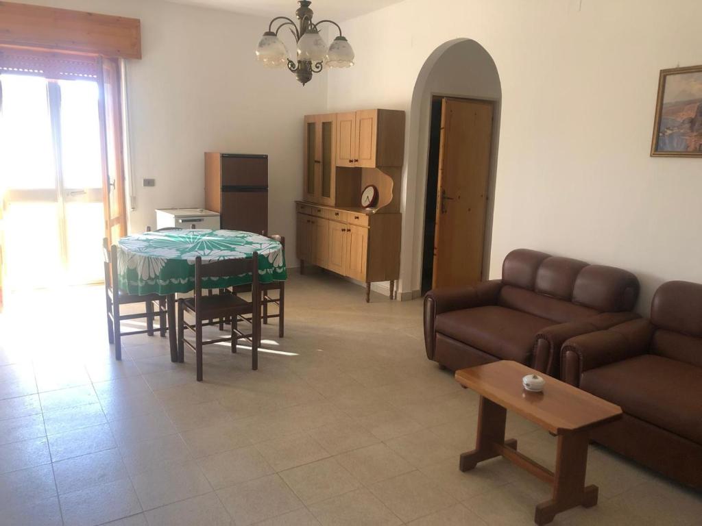a living room with a couch and a table at Casa Emilia in Ginosa Marina